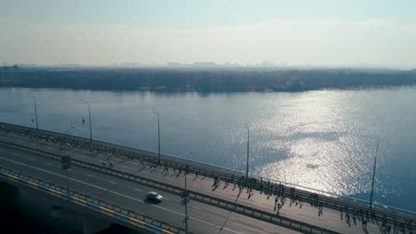 Marathon-running-on-the-bridge.-Dolly-shot