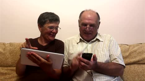 Attractive-adult-woman-and-adult-man-work-on-tablet-pc-and-smartphone.