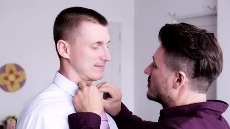 Gay-man-help-his-partner-putting-on-tie-for-job-interview.-Provide-support.