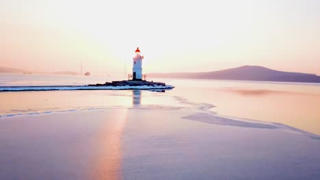 Aerial-winter-view-of-the-Tokarevskiy-lighthouse---one-of-the-oldest-lighthouses-in-the-Far-East,-still-an-important-navigational-structure-and-popular-attractions-of-Vladivostok-city,-Russia.