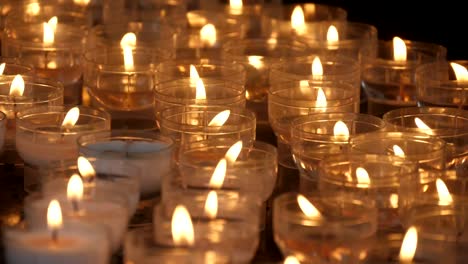 Inspiring-view-of-many-outdoor-candles-lit-in-a-Catholic-Christian-church-in-Belgium-in-slow-motion.-They-look-religious-and-gorgeous.