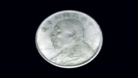 China-old-coin-(yuan)-rotates-on-a-black-background.-Macro.-Closeup