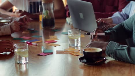 Close-up-multi-ethnic-friends-studying-together-at-cafe