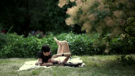 Couple-of-lesbians-laying-on-the-grass-in-the-park