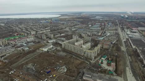 Aerial-survey-on-city.-View-from-the-sky-on-Russian-city.-Aerial-city-view-on-houses,-streets-and-parks.-Grey-sky-and-garages-really-residential-district.-Aerial-survey-on-the-street-where-drive-a-lot-of-car.Chelyabinsk.-Ural.-Overhead-Aerial-Flight-Over