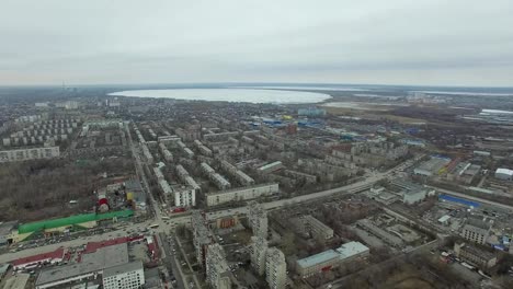 Aerial-survey-on-city.-View-from-the-sky-on-Russian-city.-Aerial-city-view-on-houses,-streets-and-parks.-Grey-sky-and-garages-really-residential-district.-Aerial-survey-on-the-street-where-drive-a-lot-of-car.Chelyabinsk.-Ural.-Overhead-Aerial-Flight-Over