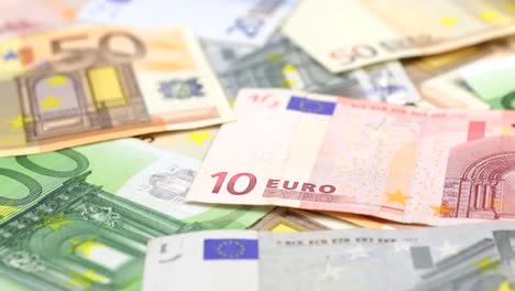 Approaching-close-up-dolly-shot-of-scattered-European-paper-money.-Dolly-shot.