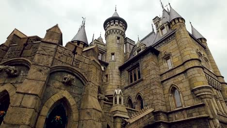 towers-of-medieval-fortress,-bas-reliefs,-stone-walls,-stained-windows,-gothic-style-in-architecture