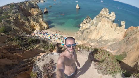 Guy-taking-a-selfie-in-a-beach-in-Algarve,-Portugal