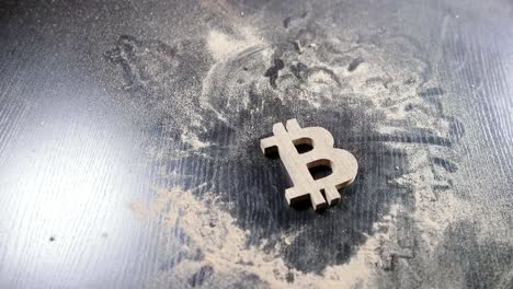 the-wooden-bitcoin-symbol-lies-on-a-dusty-table