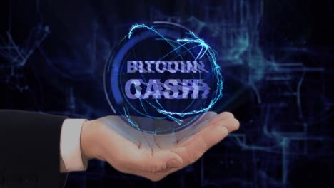 Painted-hand-shows-concept-hologram-Bitcoin-cash-on-his-hand