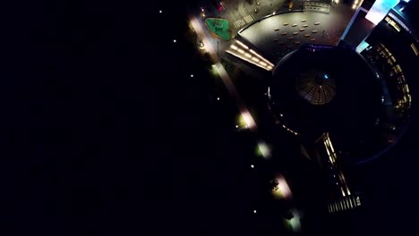 Top-view-of-modern-urban-architecture-with-domed-roof-at-night.-Video.-Modern-buildings-in-the-city-with-bright-colors-at-night