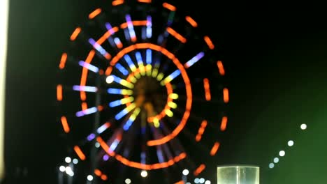 Lighted-Batumi-ferris-wheel,-view-from-bar-window,-night-view-of-beautiful-city