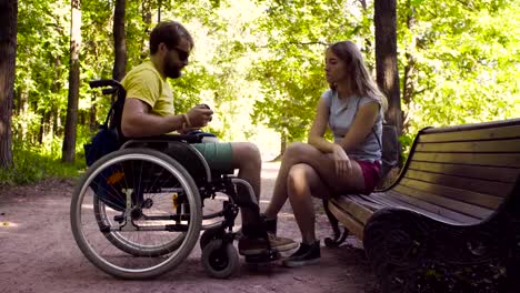 Young-disable-man-with-his-wife-on-a-walk-in-the-park