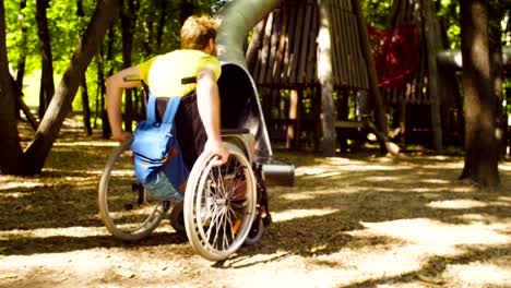 Young-disable-man-in-a-wheelchair-in-the-park