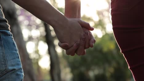 Close-up-of-hands-held-together-with-sunlight-flare-shining-through