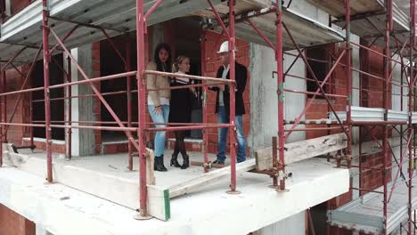 Female-Gay-Couple-Buying-New-Home-In-Construction-Site