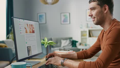 Man-Relaxing-at-Home,-Uses-Personal-Computer,-Browses-Through-Social-Network-Feed-Site.