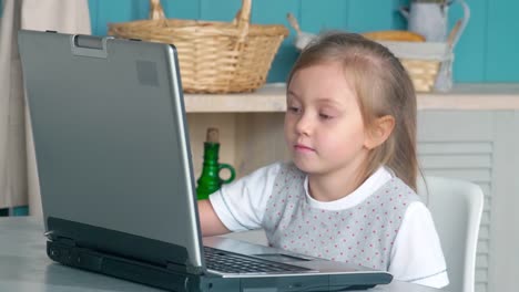 Cute-Little-Girl-Watching-Cartoon-on-Laptop