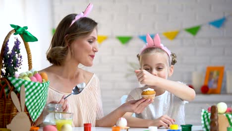 Mutter-und-Tochter-Vereisung-hausgemachte-Kuchen-und-dekorieren-sie-mit-Streusel