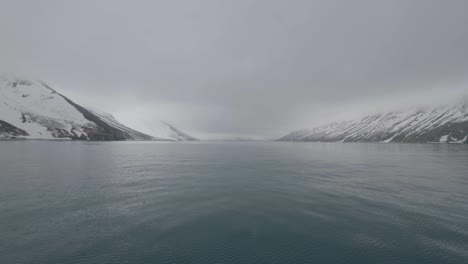 Landscape-snowy-mountain-and-smooth-water-surface-of-pacific-ocean