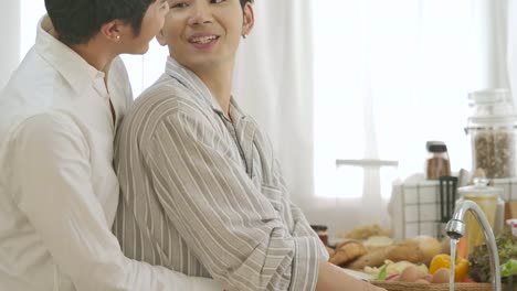 Happy-gay-couple-cooking-together-in-home-kitchen.-People-with-gay,-homosexual,-relationship-concept.