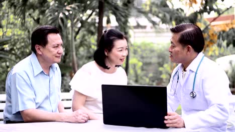 Doctor-and-patient-discussing-medical-examination-outdoor-in-garden.