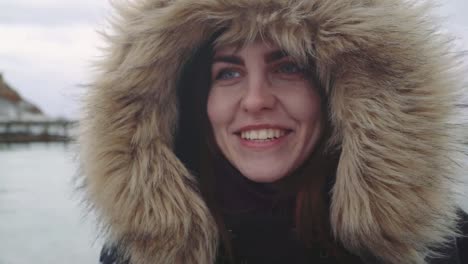 Closeup-portrait-of-a-young-beautiful-red-haired-woman-outdoors.-Girl-in-a-warm-fluffy-jacket