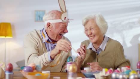 Cheerful-Elderly-Couple-Preparing-for-Easter