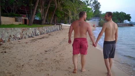 happy-gay-couple-is-resting-on-a-beautiful-tropical-beach.-LGBT-concept