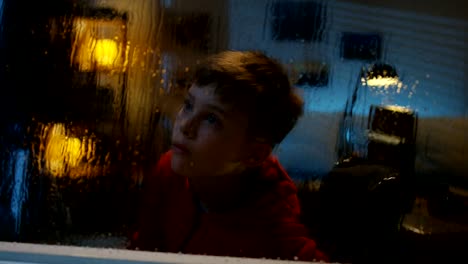 Wheelchaired-boy-watching-storm-from-room