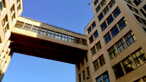 View-up-of-State-Industry-Building-or-Gosprom-built-in-Construction-Art-over-blue-sky,-sun-ray-in-the-sky