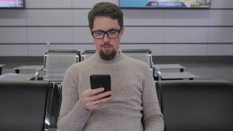 Man-is-looking-on-screen-of-smartphone