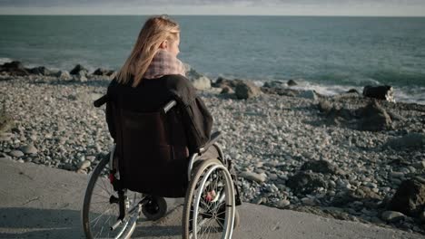 La-mujer-discapacitada-en-silla-de-ruedas-está-sola-con-el-mar