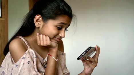 Indian-little-girl-is-Watching-cartoon-on-smartphone-slow-motion