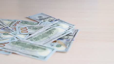 Woman-hands-take-banknotes-of-dollars-from-the-table,-close-up