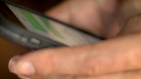 Extreme-close-up-of-man-texting-on-his-mobile-cell-smart-phone