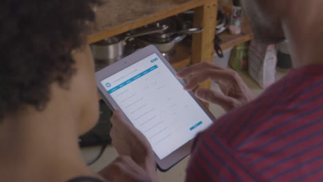 Young-couple-using-tablet-computer,-over-shoulder-view,-shot-on-R3D