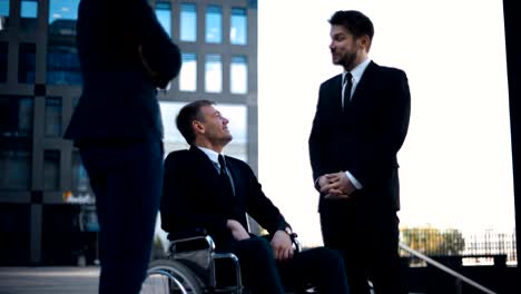 Disabled-businessman-having-fun-and-laughing-with-his-friends