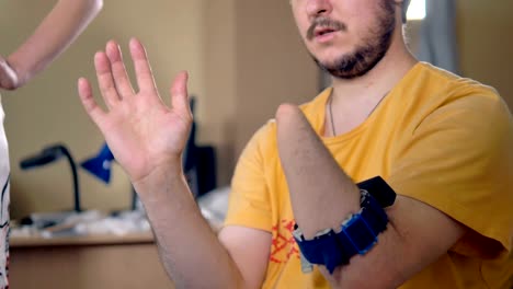 Disabled-man-with-the-amputated-hand-using-bionic-sensor-for-computer-control.-4K.