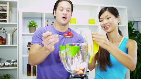 Asian-Chinese-couple-preparing-healthy-homemade-fruit-smoothie