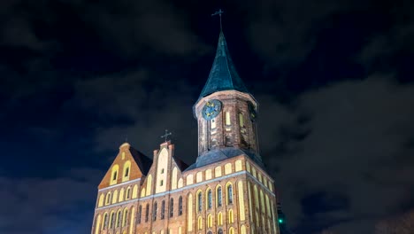 Illumination-on-a-historic-building.-Historic-Landmark.-Time-lapse.-Cathedral-of-Kant-in-Kaliningrad.-Old-medieval-castle-at-night-against-the-sky.-An-ancient-tower-with-a-clock.-Timelapse.