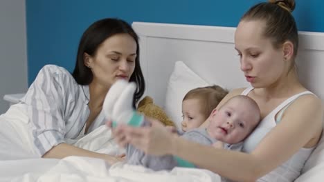 Female-Couple-Playing-with-Children-in-Morning