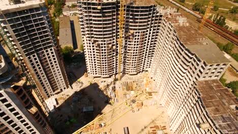 Aerial-shoot-of-construction-site-with-tower-cranes.-Construction-drone-footage