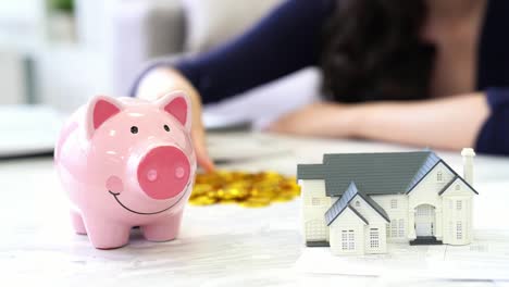 woman-saving-money-into-pink-piggy-bank