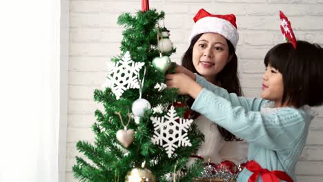 mother-and-daughter-decorating-Christmas-tree