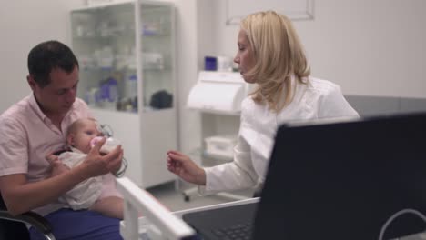 Baby-in-the-arms-of-his-father-in-the-hospital