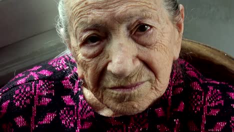 elderly-relaxed-and-serene-woman-at-home:-closeup-portrait-looking-direct-in-the