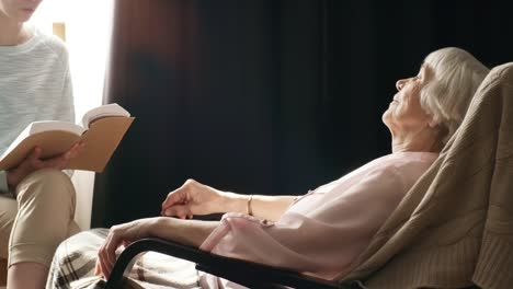 Granddaughter-Reading-Book-to-Grandmother