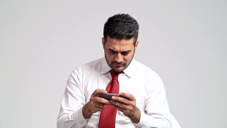 Businessman-playing-mobile-phone-games-during-office-hour.